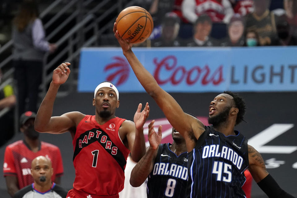 Orlando Magic forward Donta Hall (45) steals a pass intended for Toronto Raptors guard Paul Watson Jr., (1) during the second half of an NBA basketball game Friday, April 16, 2021, in Tampa, Fla. (AP Photo/Chris O'Meara)