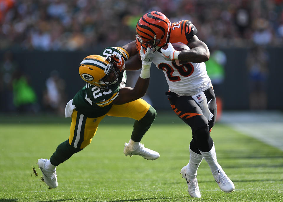 <p>Marwin Evans #25 of the Green Bay Packers grabs the face mask of Joe Mixon #28 of the Cincinnati Bengals trying to make a tackle during the first quarter of their game at Lambeau Field on September 24, 2017 in Green Bay, Wisconsin. (Photo by Stacy Revere/Getty Images) </p>