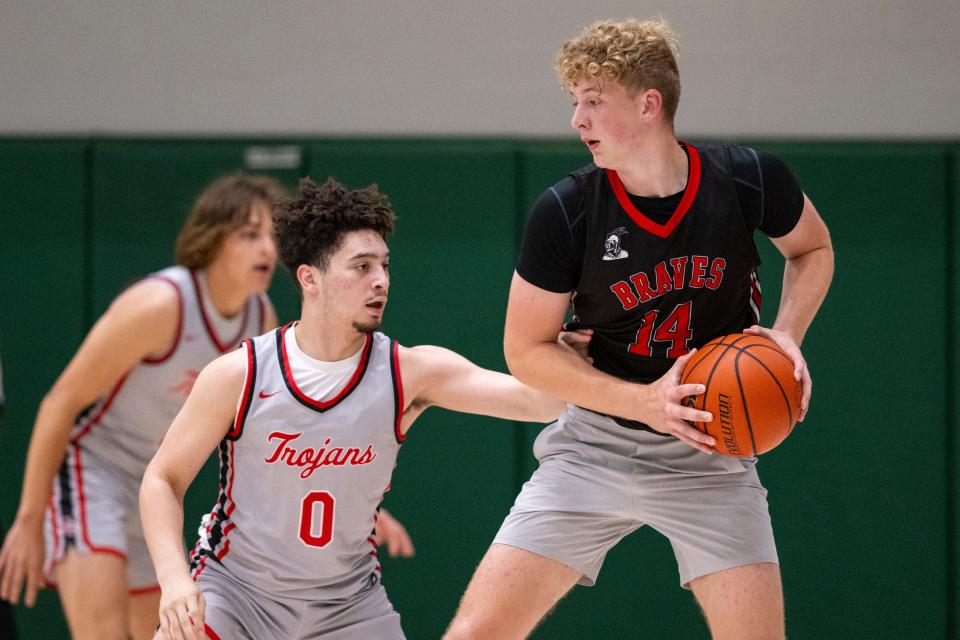 Center Grove High School's Jalen Bundy (0) defends Brownstown Central High School's Jack Benter (14) during Charlie Hughes Shootout basketball action, Saturday, June 24, 2023, at Westfield High School.