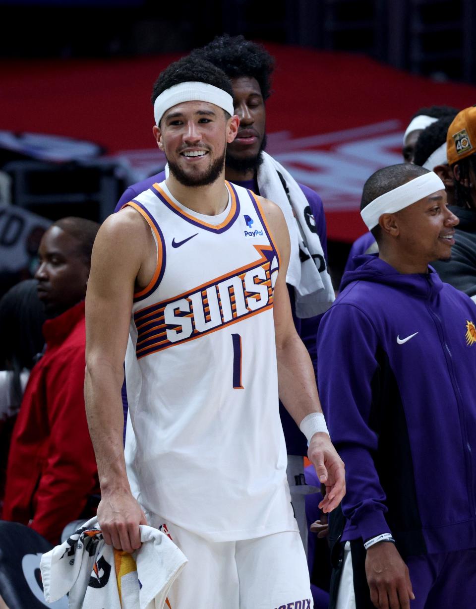 Devin Booker #1 of the Phoenix Suns smiles from the bench during a 124-108 Suns win over the LA Clippers at Crypto.com Arena on April 10, 2024 in Los Angeles, California.