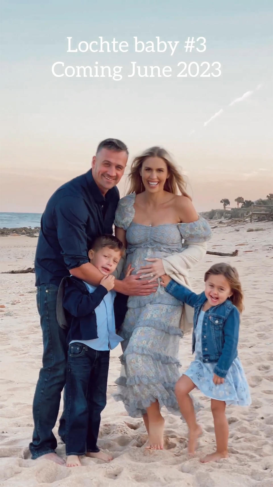 Ryan Lochte, Kayla Rae Reid, and their children, Caiden and Liv, posing on the beach to announce baby No. 3. (Kayla Rae Reid / Ryan Lochte / Instagram)