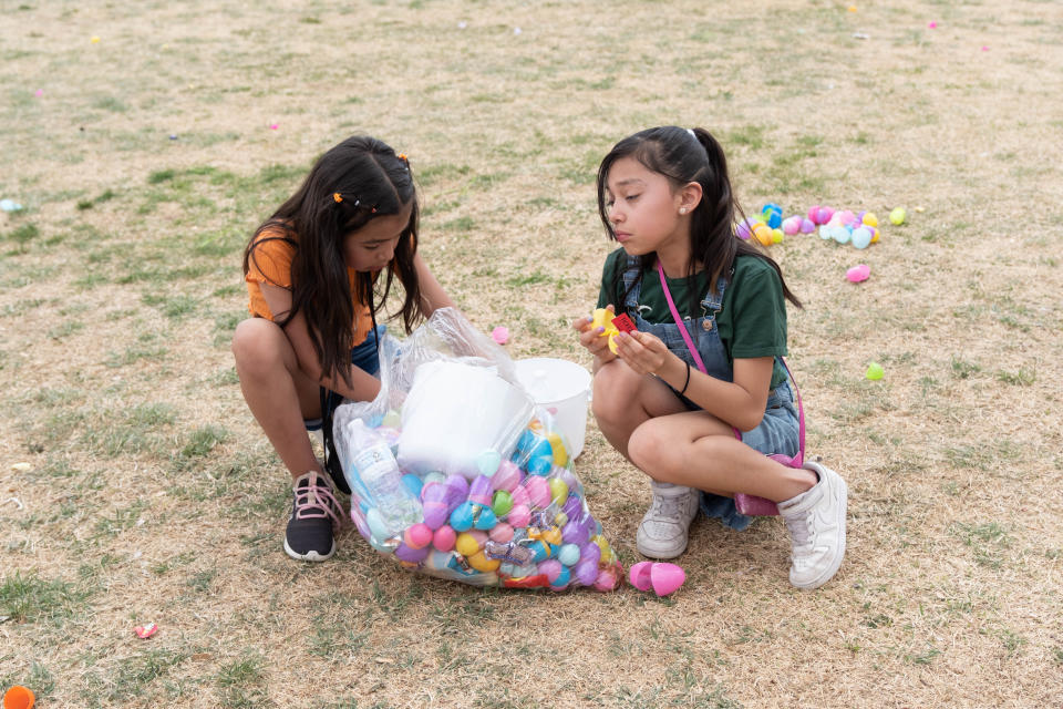 Two young girls go through their collected eggs during Shi Lee's 7th annual Citywide Easter Egg Hunt Sunday at Bones Hooks Park in Amarillo in April 2023. This year's event will be held Sunday, March 31.