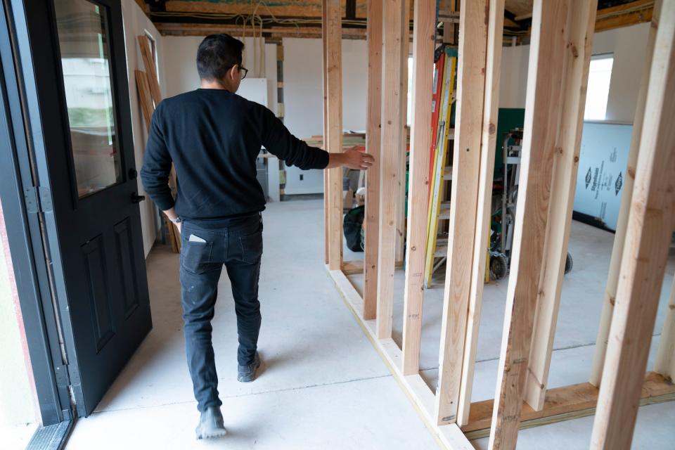 Fernando Bales, 35, of Pontiac, build lab manager of Citizen Robotics, has the distinction of being the builder of record for Michigan's first 3D-printed house in Detroit, points to framed rooms in the 1,000-square-foot house on Monday, Sept. 25, 2023.