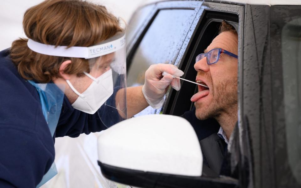 Nick Markham, the founder of ExpressTest, reacts as he takes a PCR swab test at Gatwick Airport - Leon Neal/Getty Images