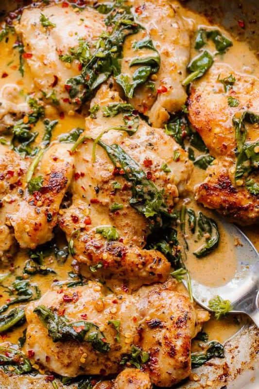Easy Weeknight Recipes<p>Full of flavor, thanks to shallots, wine and creamy spinach, this is a delicious way to serve basic boneless skinless chicken thighs.</p><p><strong>Get the recipe: <a href="https://easyweeknightrecipes.com/creamed-spinach-chicken/" rel="sponsored" target="_blank" data-ylk="slk:Creamed Spinach Chicken;elm:context_link;itc:0;sec:content-canvas" class="link "><em>Creamed Spinach Chicken</em></a></strong></p>