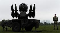 A soldier from the British Royal Artillery (R) stands by as a Rapier missile defence system, which could play a role in providing air security during the Olympics, is shown to members of the media in southeast London in May 2012. London residents lost their court battle to prevent the government placing surface-to-air missiles on the roof of their apartment block during the Olympics