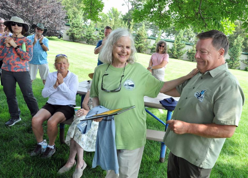 Quincy Environmental Treasures Program founder Sally Owen, of Quincy, center, is honored on her 75th birthday by Mayor Thomas Koch, right, following a tour of Merrymount Park, Sunday, July 9, 2023.
