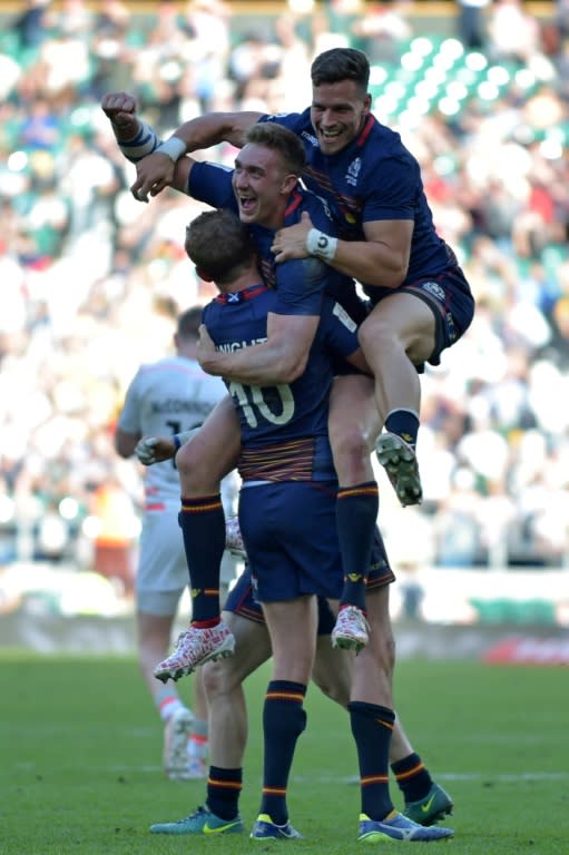 Scotland players celebrate on the pitch after their victory in the cup final match of the World Rugby Sevens Series - London on May 21, 2017