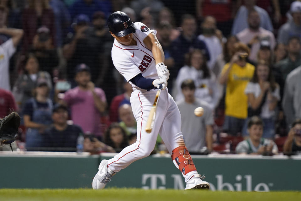 Boston Red Sox's Rob Refsnyder hits a single to drive in the winning run against the Texas Rangers during the ninth inning of a baseball game Thursday, Sept. 1, 2022, in Boston. (AP Photo/Steven Senne)