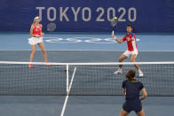 Novak Djokovic, right, and Nina Sojanovic, of Serbia, return to Luisa Stefani, bottom right, and Marcelo Melo, of Brazil, during a first round mixed doubles tennis match at the 2020 Summer Olympics, Wednesday, July 28, 2021, in Tokyo, Japan. (AP Photo/Patrick Semansky)