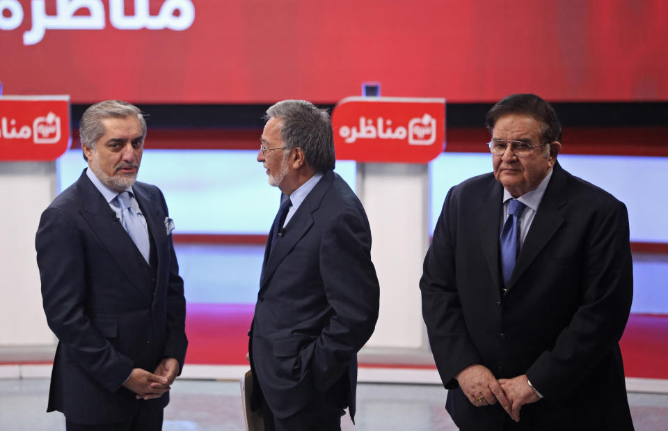 FILE - In this Tuesday, Feb. 4, 2014 file photo, Afghanistan presidential election candidates, from left, runner-up in the 2009 election, Abdullah Abdullah, former Foreign Minister Zalmai Rassoul and former Defense Minister Abdul Rahim Wardak attend the first presidential election debate at the Tolo TV building in Kabul, Afghanistan. Wardak, a longtime defense minister until he was removed by parliament in a vote of no confidence in 2012, gave no reason for his withdrawal and he was not throwing his support behind any remaining candidates, he said Sunday, March 16. (AP Photo/Massoud Hossaini, File)