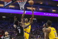 Los Angeles Lakers center Dwight Howard drives to the basket as Sacramento Kings forward Chimezie Metu (7) defends during the first quarter of an NBA basketball game in Sacramento, Calif., Tuesday, Nov. 30, 2021. (AP Photo/Randall Benton)