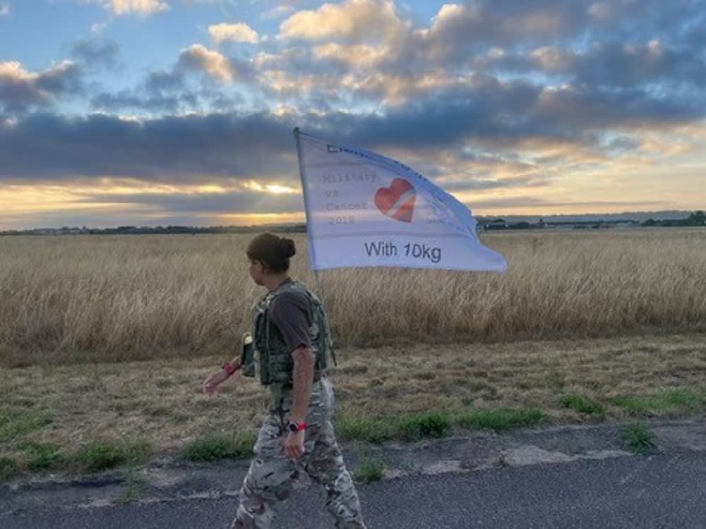 Woman walking with a flag in her hand