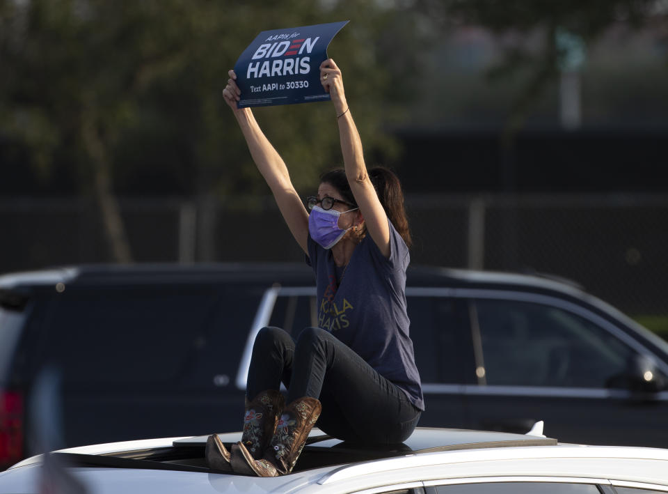 A supporters holds up a sign during a get out the vote event featuring Jill Biden, wife of Democratic presidential candidate former Vice President Joe Biden, Tuesday, Oct. 13, 2020, at NRG Stadium parking lot in Houston. (Yi-Chin Lee/Houston Chronicle via AP)