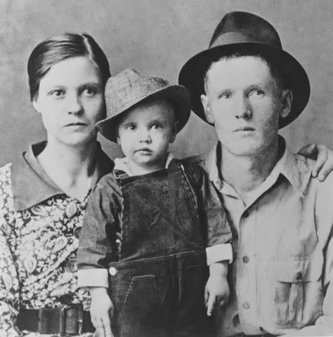 <p>Michael Ochs Archive/Getty</p> Elvis Presley, 2, with his parents Vernon Presley and Gladys Presley in 1937