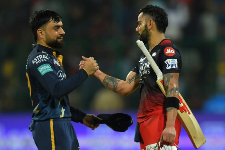 Star quality: Virat Kohli is congratulated by Gujarat's Rashid Khan after making his century