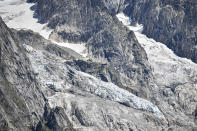 The Planpincieux glacier, located in the Alps on the Grande Jorasses peak of the Mont Blanc massif, is seen from Val Ferret, a popular hiking area on the south side of the Mont Blanc, near Courmayeur, northern Italy, Friday, Aug. 7, 2020. Some 70 people were evacuated Thursday in the valley below the glacier and roads closed after the threat of collapse the the fast-moving melting glacier is posing to the picturesque valley near the Alpine town of Courmayeur. (Claudio Furlan/LaPresse via AP)