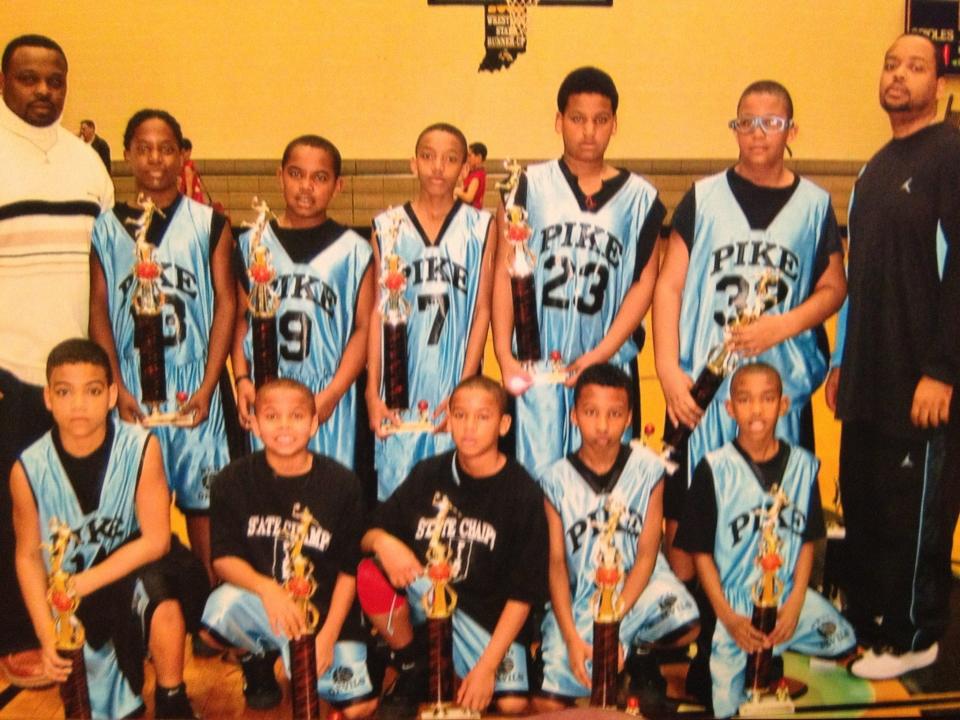 P.J. Thompson (bottom row, second from left) with a Pike youth championship team. Reynardo Bluiett (top right) coached the team. His son, Trevon Bluiett (top, second player from right) was also on the team.