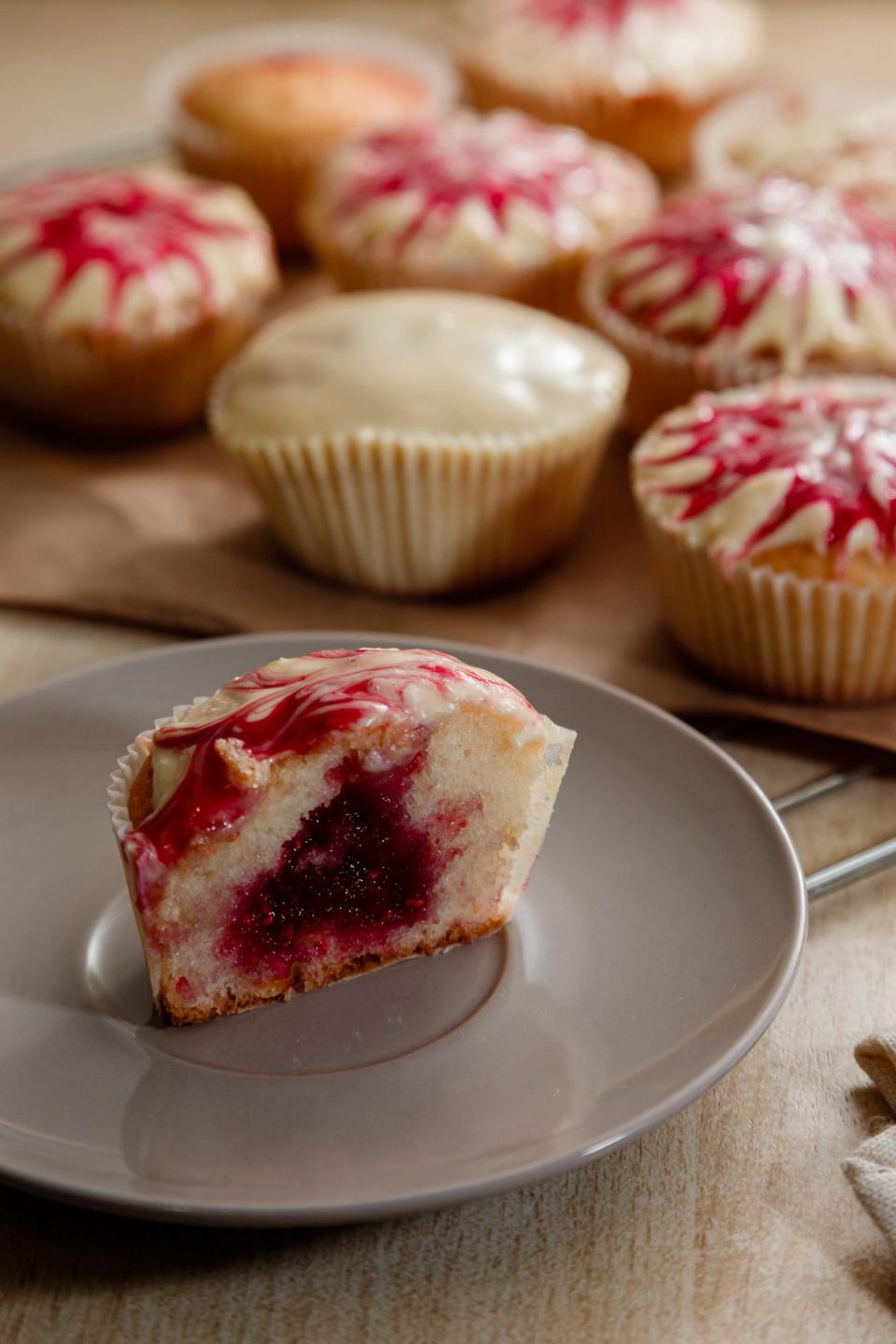 Festive white chocolate-raspberry cupcakes frosted with a blend of Whip N Ice swirled with raspberry pie filling.