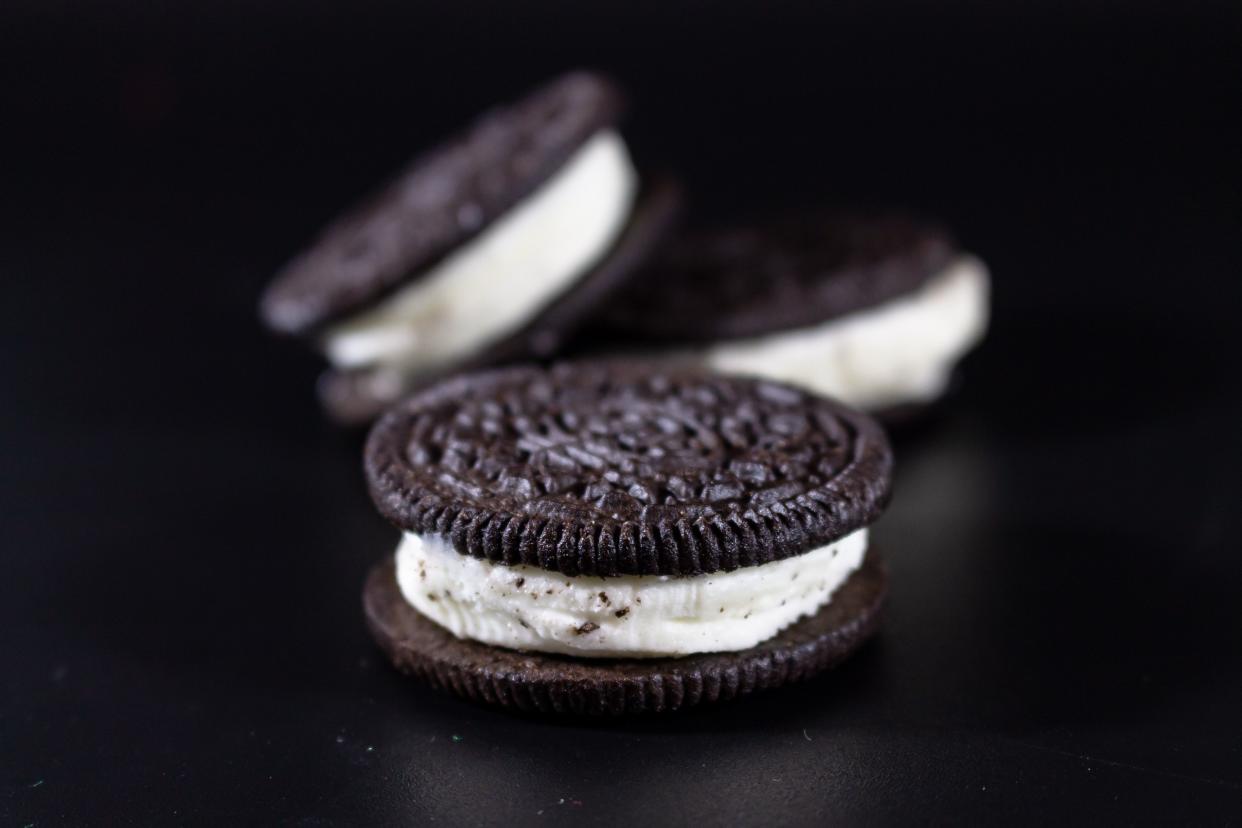 Close up of three oreo cookies on a black background