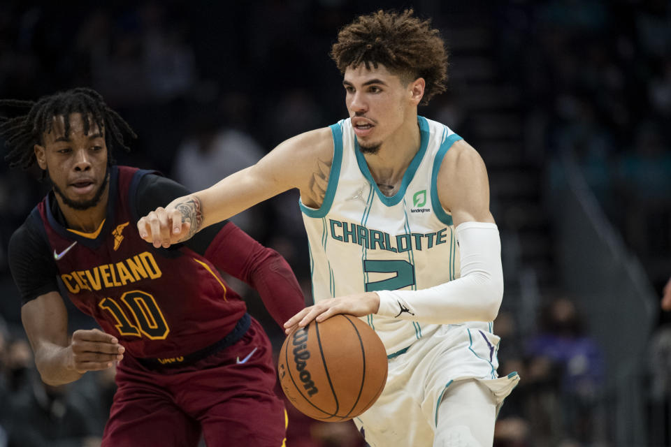 Charlotte Hornets guard LaMelo Ball (2) drives past Cleveland Cavaliers guard Darius Garland (10) during the first half of an NBA basketball game, Monday, Nov. 1, 2021, in Charlotte, N.C. (AP Photo/Matt Kelley)