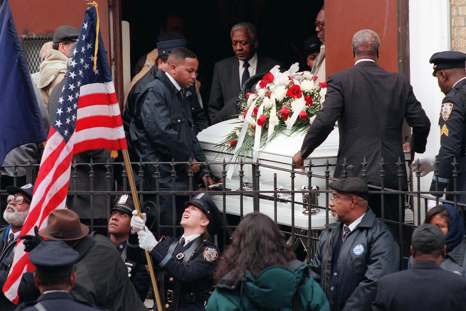 FILE - A color guard readies their flags as pallbearers carry the remains of token clerk Harry Kaufman after funeral services, in the Brooklyn borough of New York, Wednesday, Dec, 13, 1995. Kaufman died after suffering burns over 70 percent of his body in a subway token booth torching incident. Prosecutors are disavowing the convictions of three men who spent decades in prison for one of the most horrifying crimes of New York's violent 1990s — the killing of a clerk who was set on fire in a subway toll booth. (AP Photo/Kathy Willens, File)