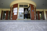 Voter Christina Tremblay, of Providence, R.I., steps out of a voting station at the historic Casino function hall at Roger Williams Park, Tuesday, June 2, 2020, in Providence. In-person voting is being offered at a reduced number of locations for voters who missed the deadline to request a mail ballot. (AP Photo/Steven Senne)