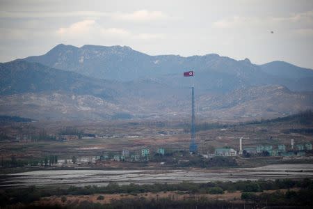 A North Korean flag flutters on top of a 160-metre tower in North Korea's propaganda village of Gijungdong, in this picture taken from the Dora observatory near the demilitarised zone separating the two Koreas, in Paju, South Korea, April 24, 2018. REUTERS/Kim Hong-Ji/Files