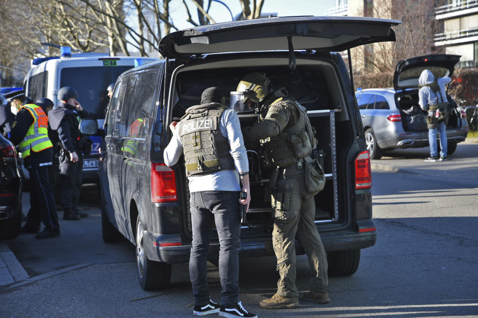 Members of the SEK stand by a vehicle on the campus of Heidelberg University in Heidelberg, Germany, Monday, Jan. 24, 2022. German police say a lone gunman wounded several people at a lecture theatre in the southwest city of Heidelberg on Monday. Police said in a brief statement that the perpetrator was dead but didn’t give details of how that happened. (R.Priebe/Pr-Video/dpa via AP)