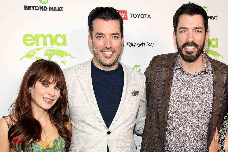 <p>Jesse Grant/Getty</p> Zooey Deschanel, Jonathan Scott and Drew Scott attend the EMA Awards Gala in October 2021