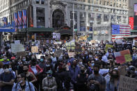 Protesters gather in Times Square before marching through the streets of Manhattan in New York, Monday, June 1, 2020. New York City imposed an 11 p.m. curfew Monday as the nation's biggest city tried to head off another night of destruction erupting amid protests over George Floyd's death. (AP Photo/Seth Wenig)