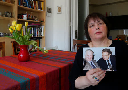 Maria Vasarhelyi, a Hungarian sociologist and opposition activist, holds a picture of billionaire philanthropist George Soros with her late father Miklos Vasarhelyi, who led the Soros Foundation in Hungary in the 1980s and 1990s, in Budapest, Hungary, March 3, 2017. REUTERS/Laszlo Balogh