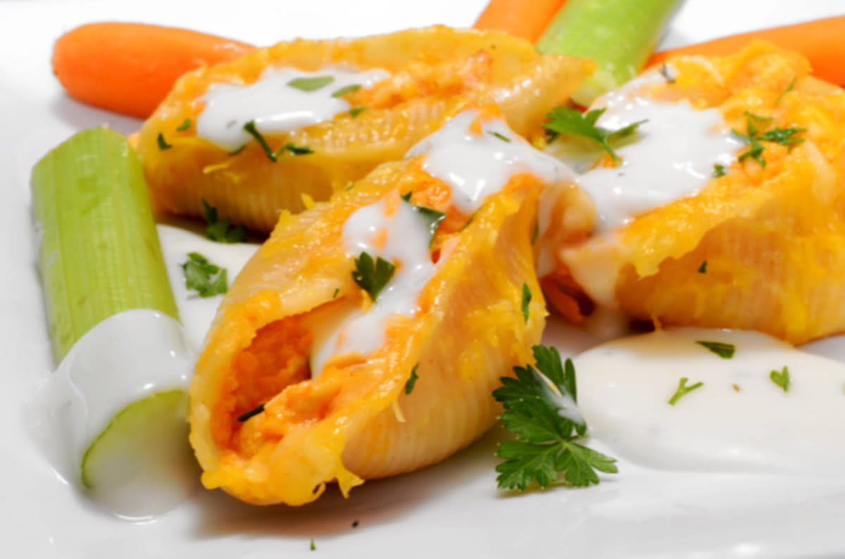 <p>Platter Talk</p><p>These tangy spiced stuffed shells are a great choice for a game day appetizer or a lite party fare bite.</p><p><strong>Get the recipe: <a href="http://www.plattertalk.com/buffalo-chicken-stuffed-shells/" rel="nofollow noopener" target="_blank" data-ylk="slk:Buffalo Chicken Stuffed Shells;elm:context_link;itc:0;sec:content-canvas" class="link rapid-noclick-resp">Buffalo Chicken Stuffed Shells</a></strong></p>