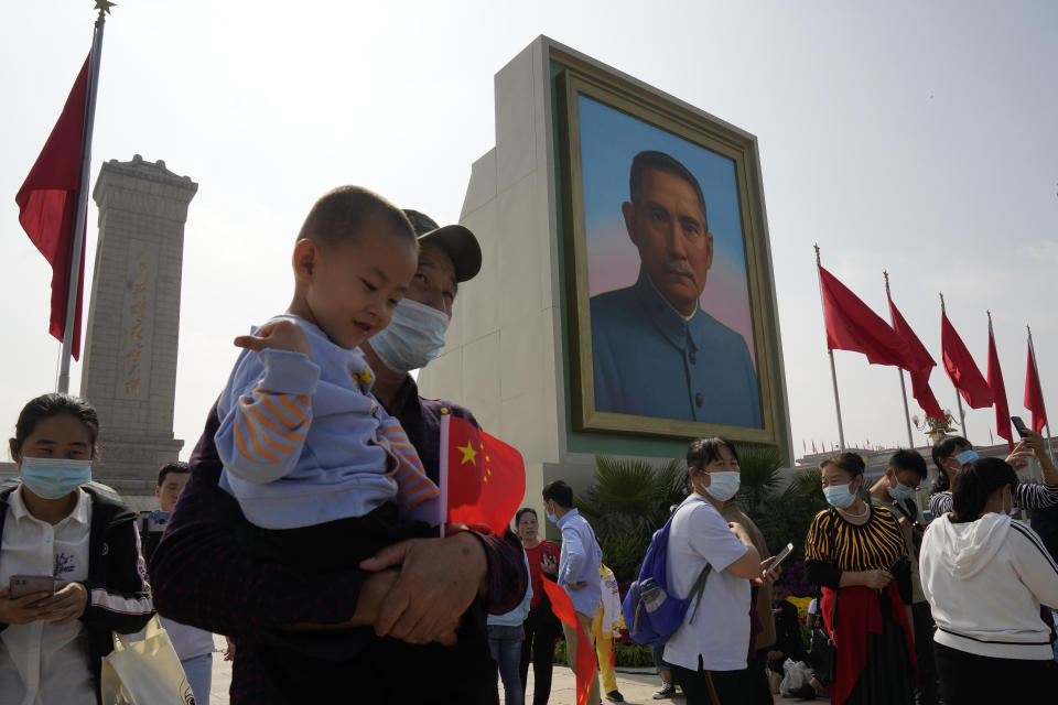 Tourists wearing masks to protect from the coronavirus stand near a portrait of Sun Yat-sen, who is widely regarded as the founding father of modern China, on Tiananmen Square in Beijing on Thursday, Oct. 1, 2020. Negative perceptions of China have increased sharply in many of the world's advanced economies, especially in Australia and the U.K., a new survey from the Pew Research Center showed Tuesday, Oct. 6, 2020. (AP Photo/Ng Han Guan)