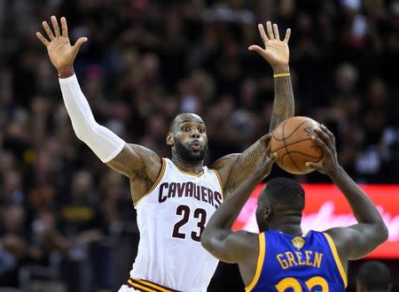 Cleveland Cavaliers forward LeBron James (23) defends against Golden State Warriors forward Draymond Green (23) during the fourth quarter in game six of the NBA Finals at Quicken Loans Arena. Mandatory Credit: Bob Donnan-USA TODAY Sports