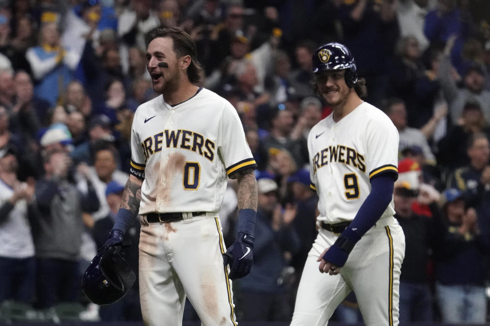 Milwaukee Brewers' Brice Turang (0) reacts with Brian Anderson (9) after hitting a grand slam during the fifth inning of a baseball game against the New York Mets Monday, April 3, 2023, in Milwaukee. (AP Photo/Aaron Gash)