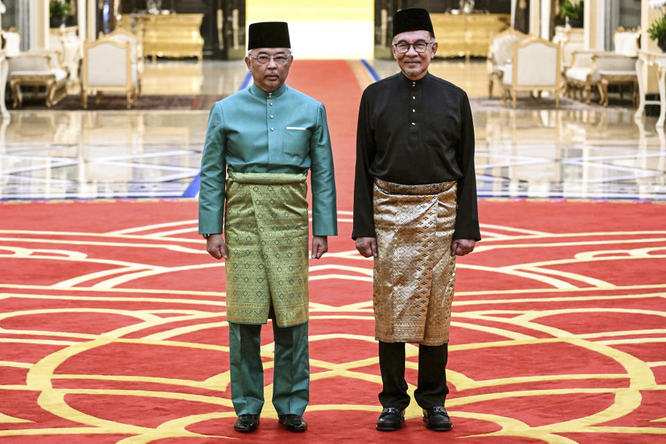 Malaysia's King Sultan Abdullah Sultan Ahmad Shah, left, and newly appointed Prime Minister Anwar Ibrahim pose after the swearing-in ceremony at the National Palace in Kuala Lumpur, Malaysia, Thursday, Nov. 24, 2022. Malaysia's king on Thursday named Anwar as the country's prime minister, ending days of uncertainty after the divisive general election produced a hung Parliament. (Mohd Rasfan/Pool Photo via AP)