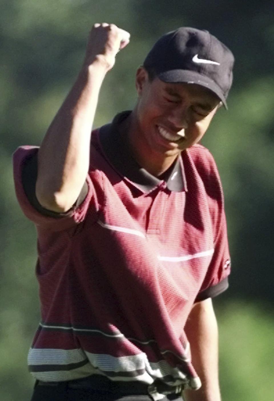 FILE - Tiger Woods celebrates after winning the 81st PGA Championship at the Medinah Country Club in Medinah, Ill., on Sunday, Aug. 15, 1999. The win started a stretch of Woods winning five of six major championships.(AP Photo/Morry Gash, File)