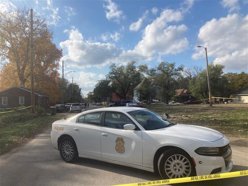 An Indianapolis Metropolitan Police Department vehicle sits parked behind crime scene tape in the 2700 block of Station Street. Police investigated after two people were shot in the area on Oct. 27, 2023.