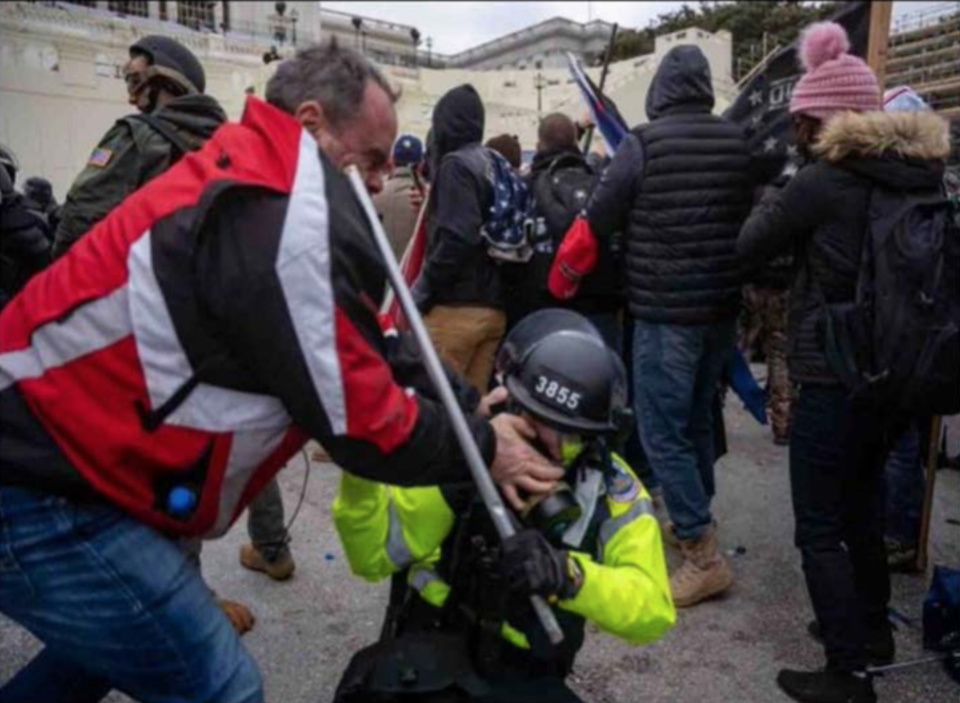 Thomas Webster of Goshen is shown grabbing the gas mask of a police officer outside the U.S. Capitol on Jan. 6 in an image prosecutors provided in court papers. The former Marine and retired New York City police officer was convicted of six charges, including assault, for actions during the pro-Trump riot. The jury rejected his claim of self-defense.