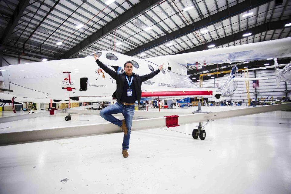 David Perez, who is excited about being the first Moroccan-decent Jew in space, strikes a pose in front of the Virgin Galactic spaceship that will take him 50 miles high.