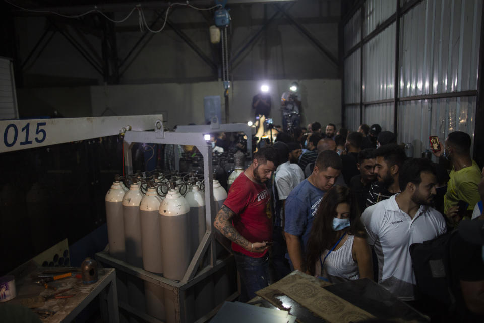 Journalists tour the metal factory near a gas facility where Israeli Prime Minister Benjamin Netanyahu said in a statement that the Hezbollah group is storing missiles close to Beirut's airport in Beirut's southern neighborhood of Jnah, Lebanon, Tuesday, Sept. 29, 2020. Hezbollah denied the allegations and invited media outlets to immediately visit the site, where they found a small factory housing heavy machinery but no evidence of weapons. (AP Photo/Hassan Ammar)