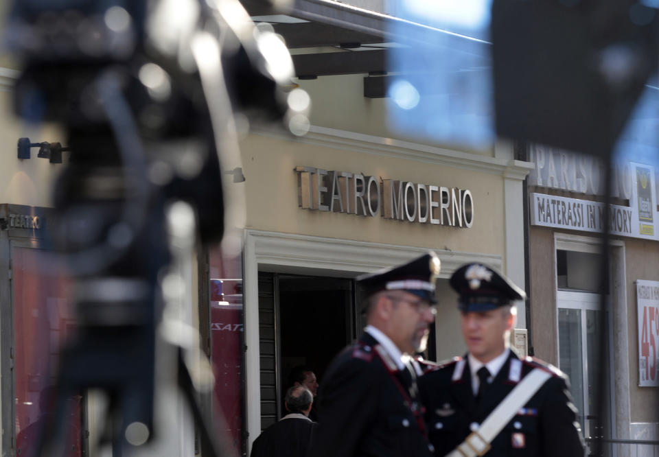 Italian Carabinieri paramilitary police officers patrol in front of the Teatro Moderno theater, where the first hearing of a trial for the Jan. 13, 2012 shipwreck of the Costa Concordia cruise liner in which 32 died is taking place, in Grosseto, Italy, Monday, Oct. 15, 2012. (AP Photo/Gregorio Borgia)