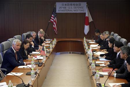 U.S. Secretary of Defense Chuck Hagel (L) speaks as Japan's Defense Minister Itsunori Onodera (3rd R) listens during their meeting at the defense ministry in Tokyo April 6, 2014. REUTERS/Eugene Hoshiko/Pool