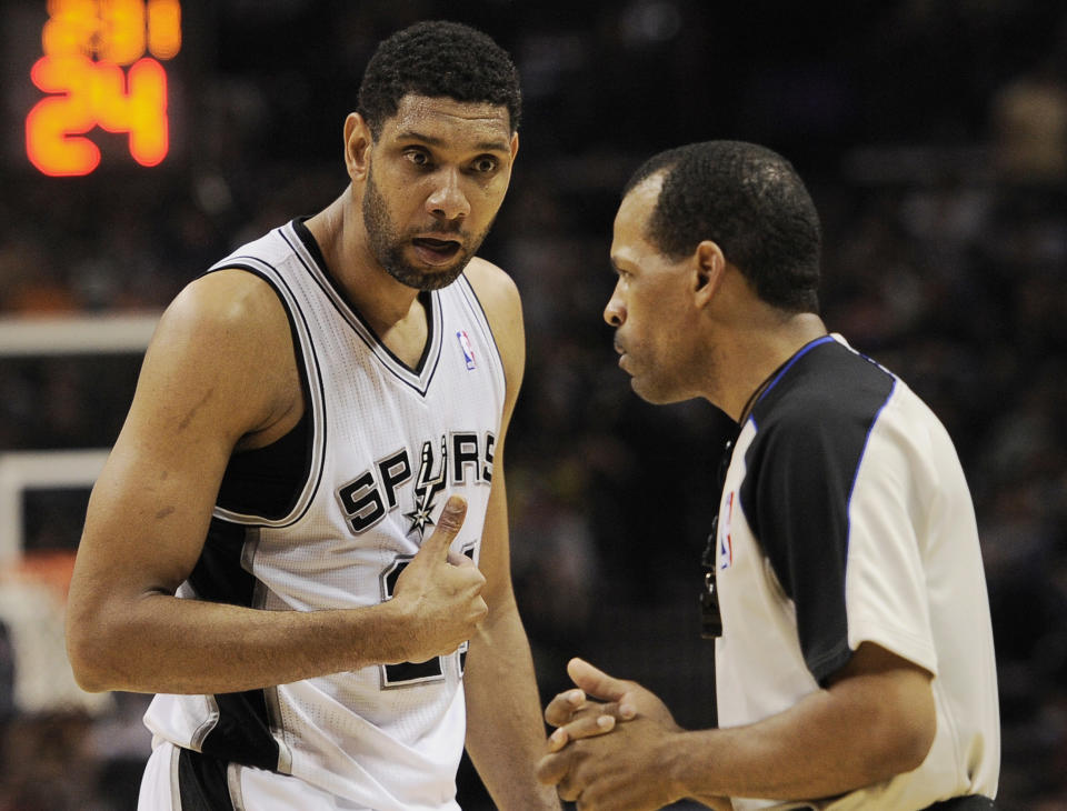 San Antonio Spurs forward Tim Duncan, left, talks to official Eric Lewis during the first half of an NBA basketball game against the Golden State Warriors, Wednesday, April 2, 2014, in San Antonio. (AP Photo/Darren Abate)