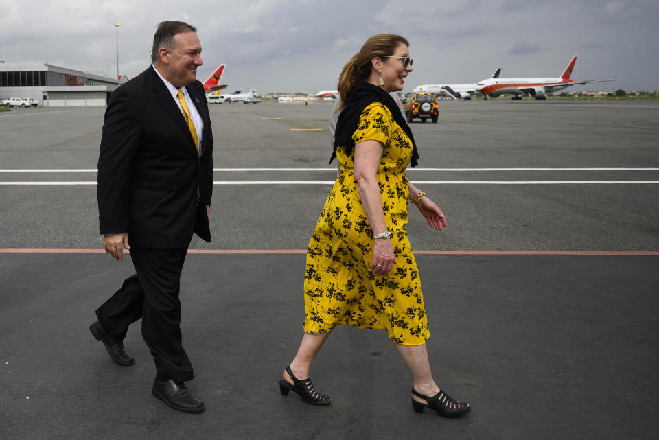 US Secretary of State, Mike Pompeo, right, and his wife, Susan Pompeo walk on the tarmac before leaving Angola at the Luanda International Airport in Luanda, Angola, Monday Feb. 17, 2020. Pompeo started his tour of Africa in Senegal, the first U.S. Cabinet official to visit in more than 18 months. He left Senegal Sunday to arrive in Angola and will then travel on to Ethiopia as the Trump administration tries to counter the growing interest of China, Russia and other global powers in Africa and its booming young population of more than 1.2 billion. (Andrew Caballero-Reynolds/Pool via AP)
