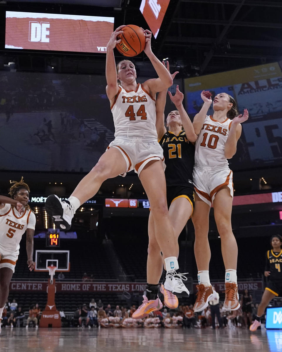 Texas forward Taylor Jones (44) grabs a rebound over Long Beach State forward Abby Shoff (21) during the second half of an NCAA college basketball game in Austin, Texas, Wednesday, Dec. 6, 2023. (AP Photo/Eric Gay)