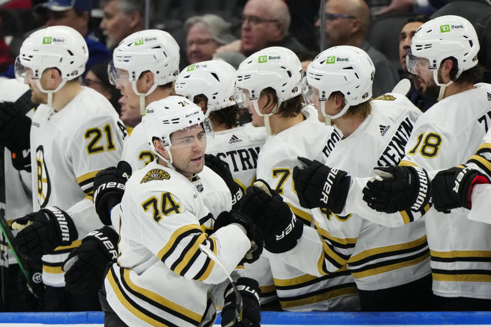 Boston Bruins left wing Jake DeBrusk (74) celebrates after his goal against the Toronto Maple Leafs with teammates during second-period NHL hockey game action in Toronto, Monday, March 4, 2024. (Frank Gunn/The Canadian Press via AP)