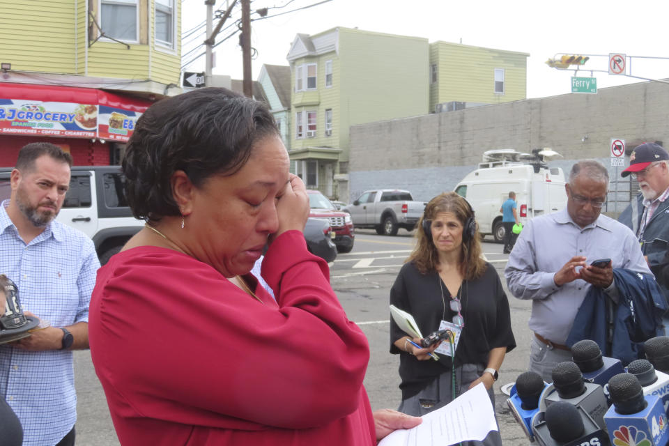 Michele Brooks, whose husband Wayne Brooks Jr. was one of two Newark, N.J. firefighters killed battling a blaze on a cargo ship in Newark in July, speaks during a news conference in Newark on Friday, Oct. 6, 2023. Families of the dead firefighters blamed the blaze on a malfunctioning vehicle being used to load the ship on the day of the fire. (AP Photo/Wayne Parry)