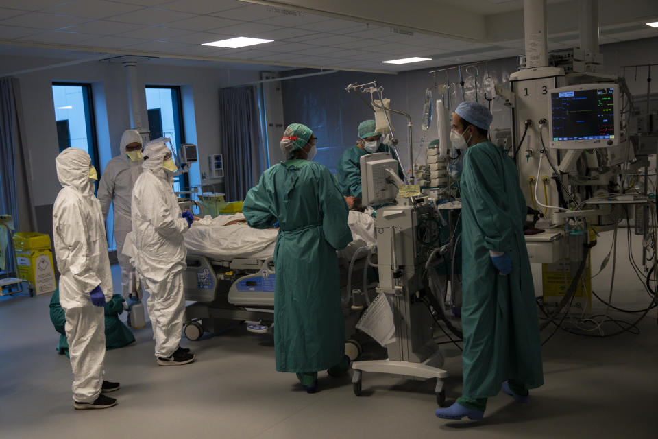 Medical personnel work in the intensive care ward for COVID-19 patients at the MontLegia CHC hospital in Liege, Belgium, Friday, Nov. 6, 2020. Coronavirus cases have surged around Europe in recent weeks, putting fresh pressure on overworked medical staff and hospitals, and forcing several countries to impose tough new movement restrictions. (AP Photo/Francisco Seco)